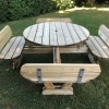 Classic round picnic table with seat backs and umbrella hole on garden lawn