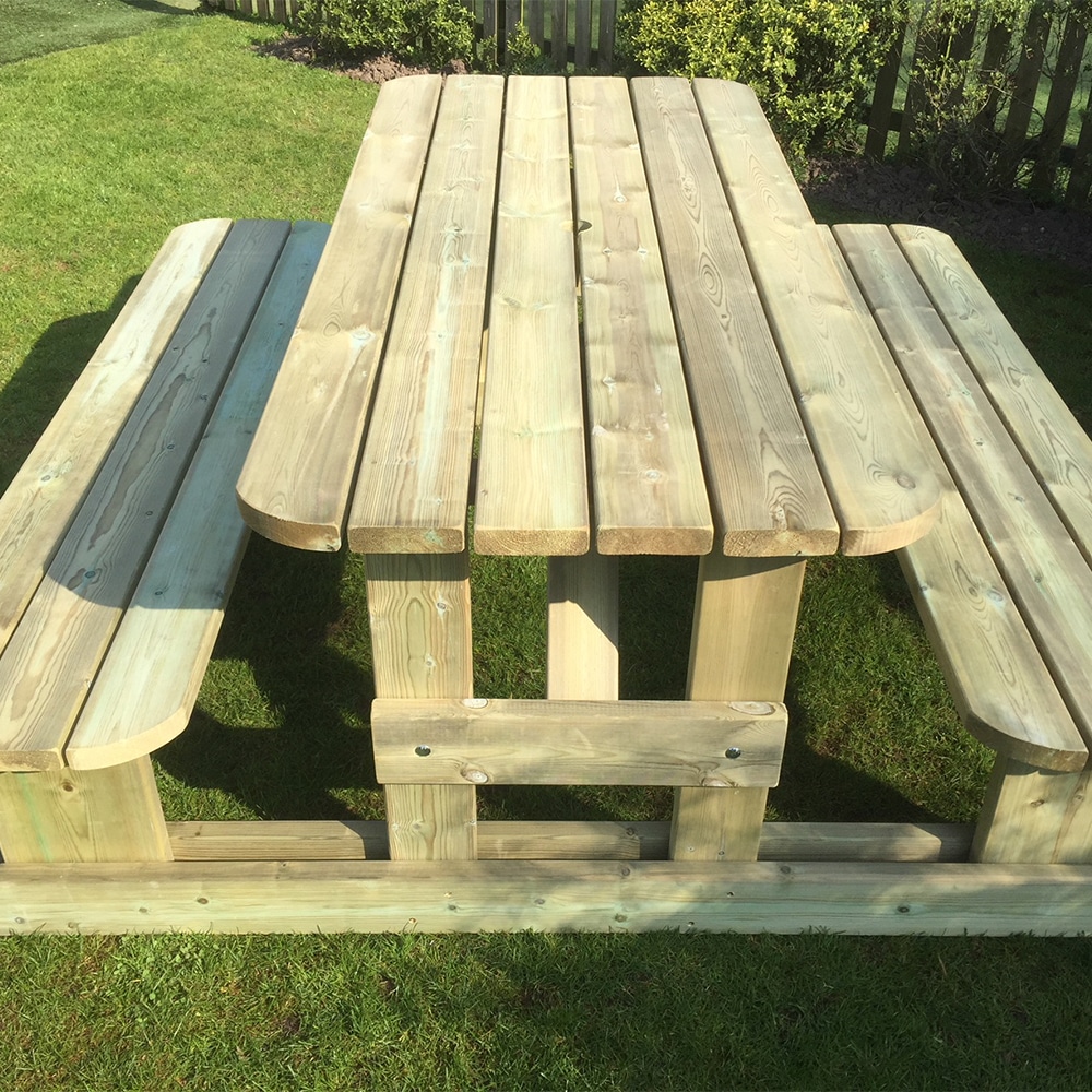 8 seater timber picnic table with rounded adges and H-frame design in garden