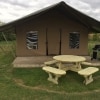 Traditional round picnic table with wooden frame at a glamping site
