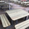 Multiple traditional pub style picnic benches for 12 people with steel frames and rounded edges in a hospitality venue beer garden