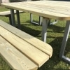 Modern timber picnic table with steel frame and rounded edges on lawn