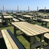 H-frame timber picnic benches with rounded edges in seaside hospitality venue