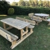 One H-frame timber picnic bench with rounded edges and one traditional round picnic bench