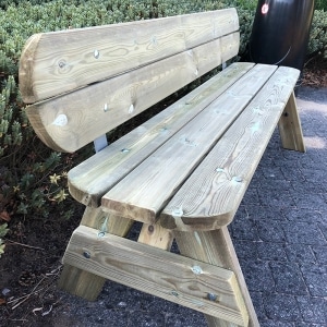 Traditional park style timber bench with rounded edges in outdoor seating area