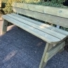 Long timber park bench with a back rest and rounded edges in outdoor seating area