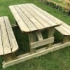 Timber H-frame outdoor picnic table with rounded edges in garden area