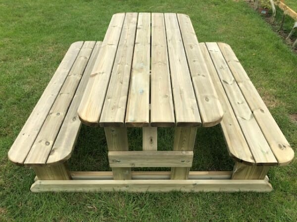Classic picnic bench seating 8 people with rounded edges in garden