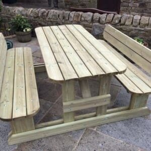 8-seater wooden walk in picnic bench with rounded edges and seat backs in outdoors courtyard