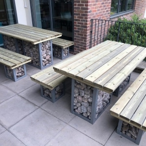8 seater outdoor wooden table and benches with stone filled steel gabions